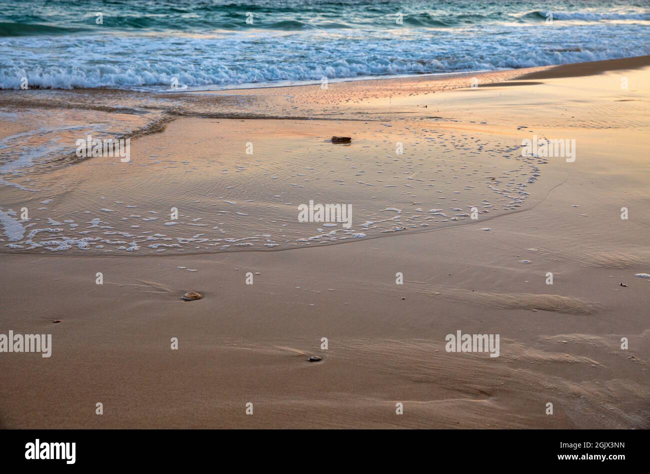 Evening surf on the sea sandy beach, Cyprus Stock Photo