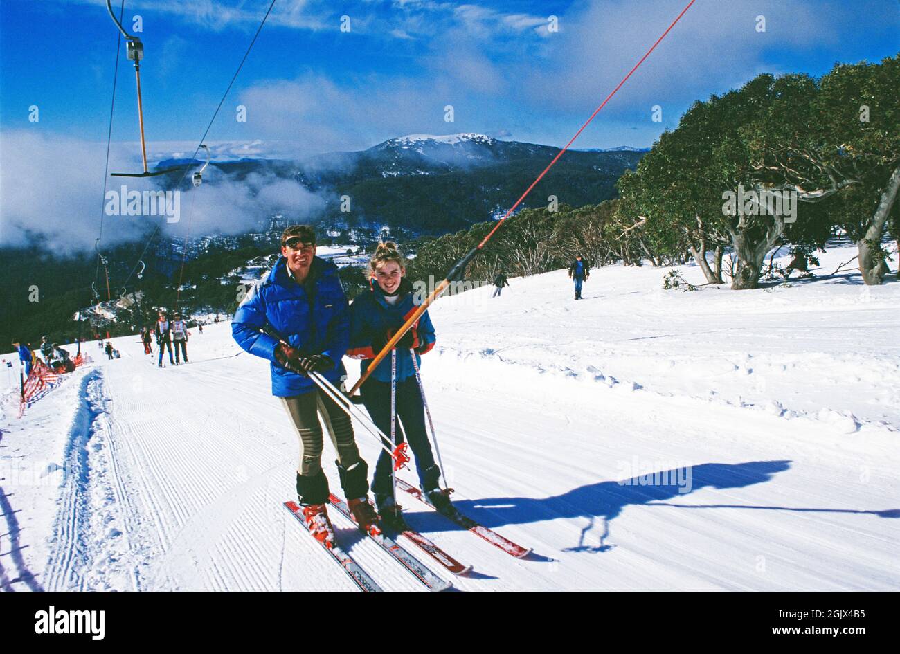 Australia. New South Wales. Thredbo ski resort. Skiers on Karels T-bar lift. Stock Photo