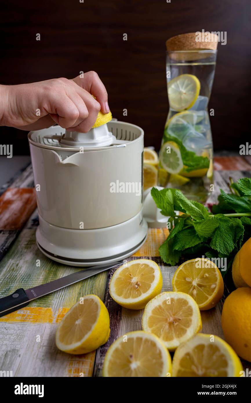 Preparation of fresh juices press on fresh lemon and lime. lemon squeezer machine or lemon presser Stock Photo Alamy