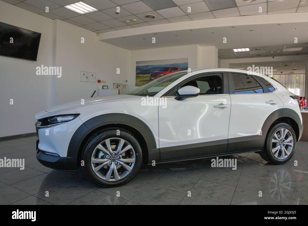 KYIV, UKRAINE - MAY 10, 2021: New white Mazda CX-30 car on display in car dealership Auto International. Crossover SUV manufactured in Japan by Mazda Stock Photo