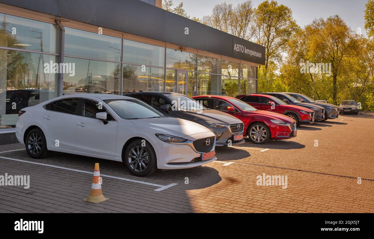 KYIV, UKRAINE - MAY 10, 2021: New Mazda cars on display in front of car dealership Auto International. Cars manufactured in Japan by Mazda Motor Corpo Stock Photo
