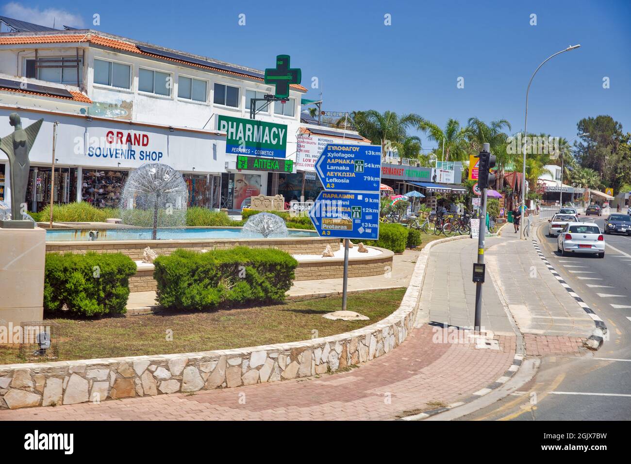 AYIA NAPA, CYPRUS - MAY 22, 2021: People sytroll along summer sunny Nissi Avenue in city center. Ayia Napa is a tourist resort at the far eastern end Stock Photo