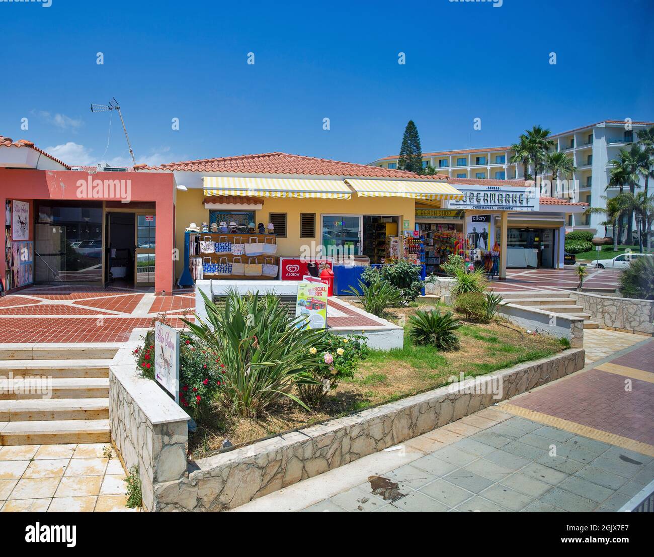 AYIA NAPA, CYPRUS - MAY 22, 2021: Small shops along summer sunny Nissi Avenue in city center. Ayia Napa is a tourist resort at the far eastern end of Stock Photo