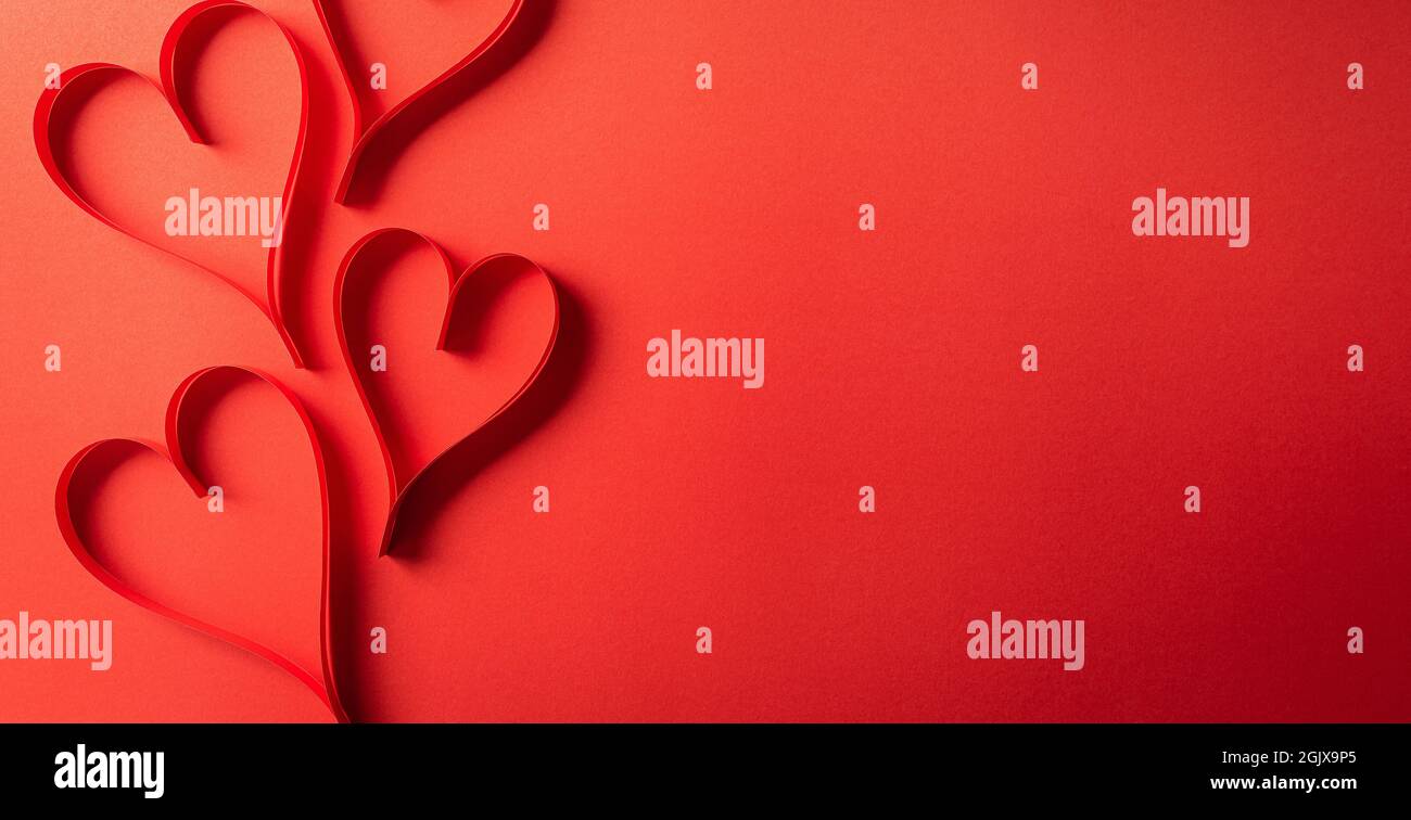 Top view of red paper hearts on red paper background with copy space ...