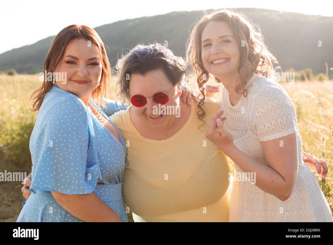 The happy girlfriends are hugging in nature Stock Photo