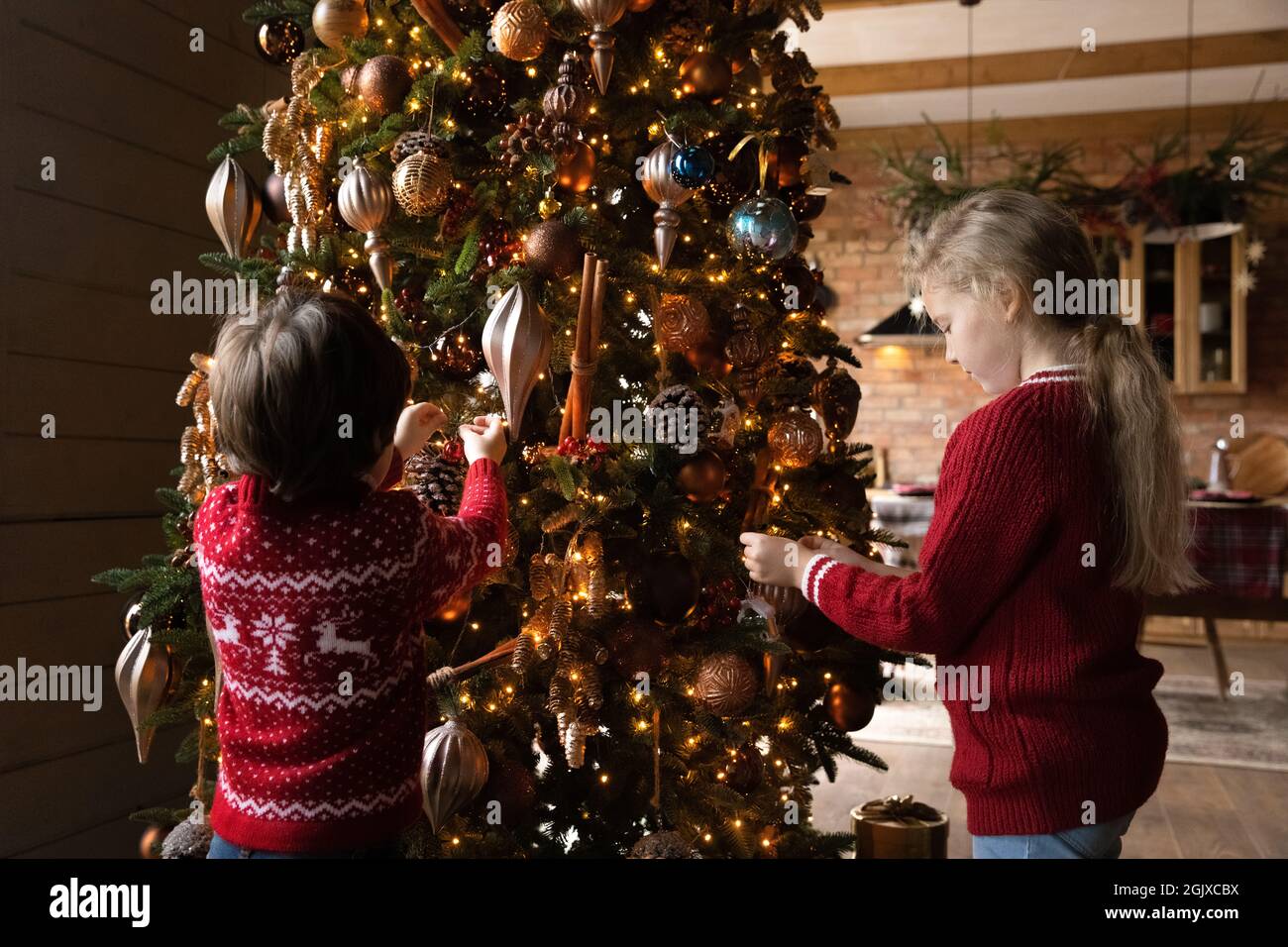Happy little children siblings designing Christmas tree using ...