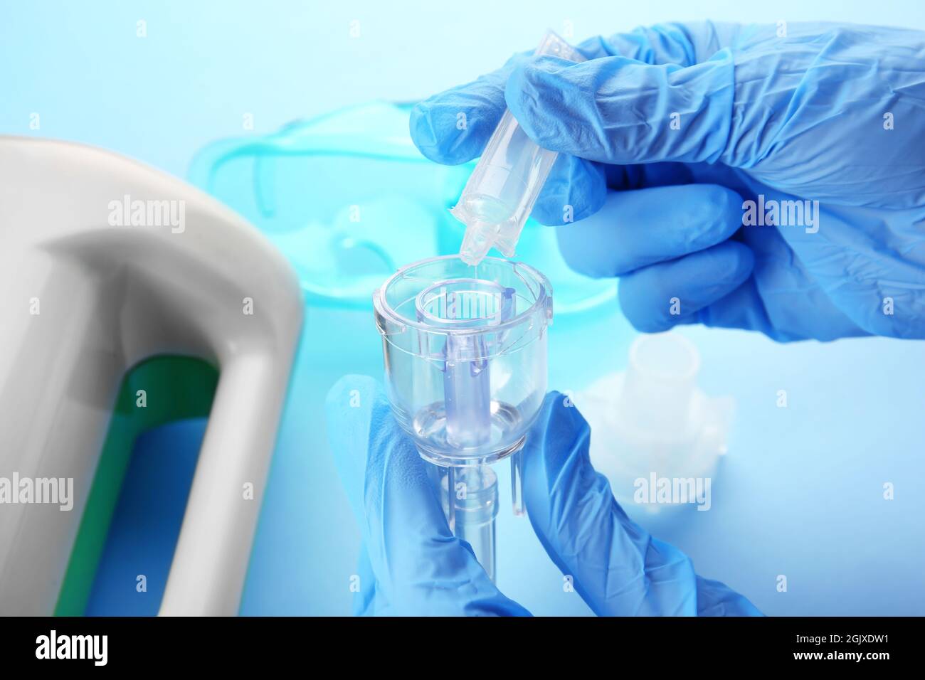 Doctor filling medication cup with remedy for inhalation therapy Stock