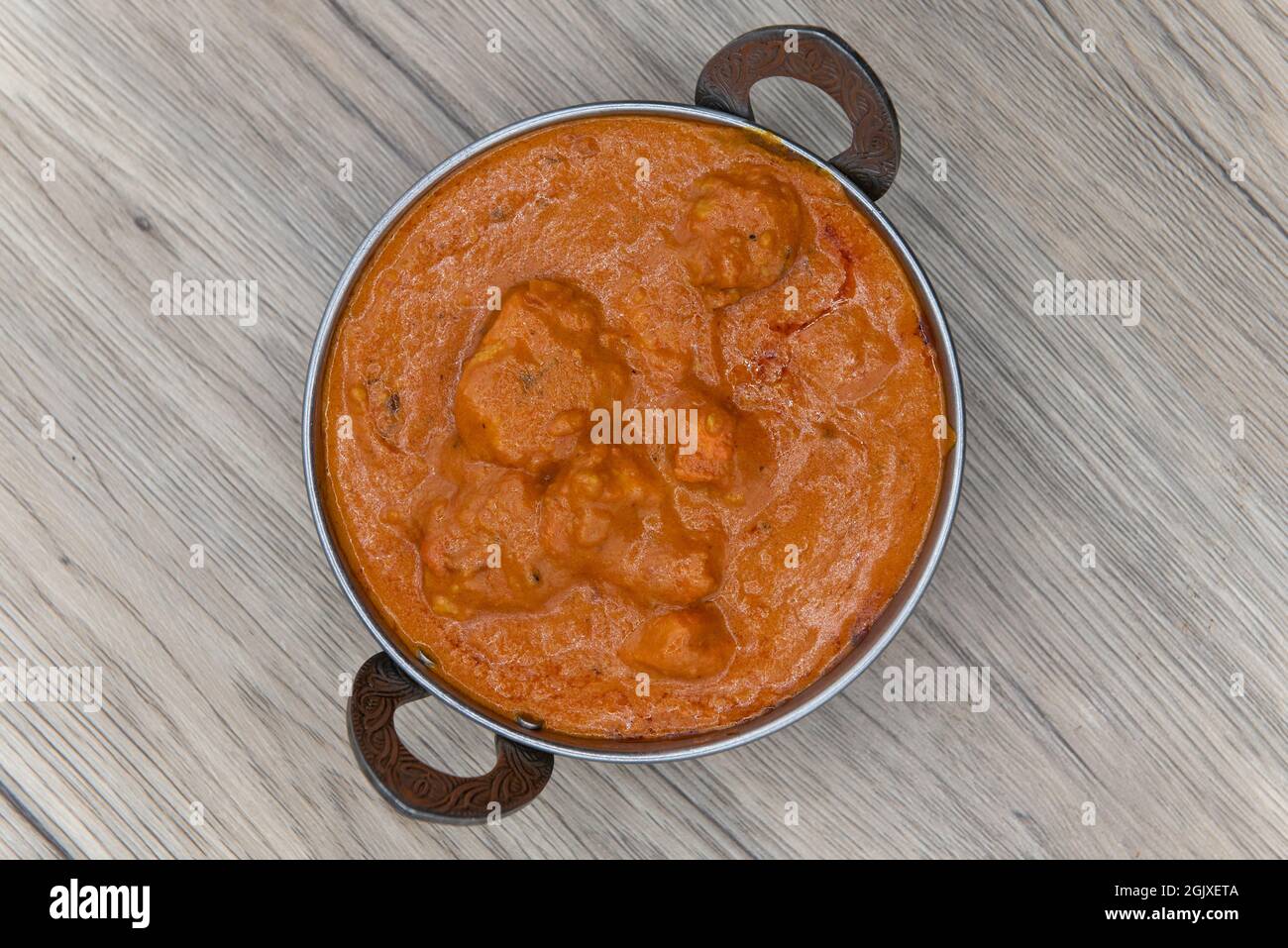 Overhead view of masala flavored tikken chicken meat in a bowl from Indian restaurant cooked and seasoned perfectly. Stock Photo
