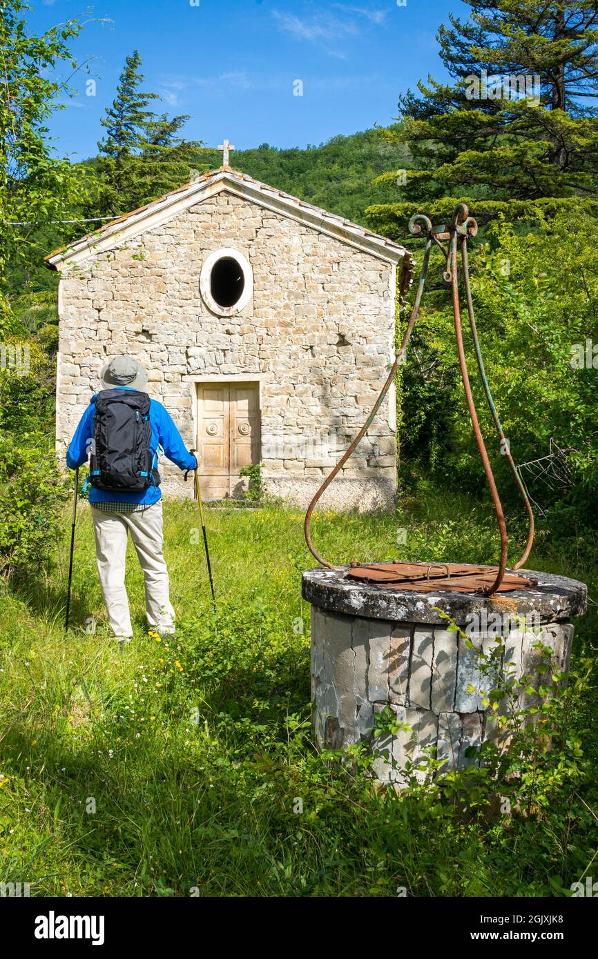 Man with backpack admiring  the ruins of the old church of Santa Caterina. Modigliana, Forlì, Emilia Romagna, Italy, Europe. Stock Photo