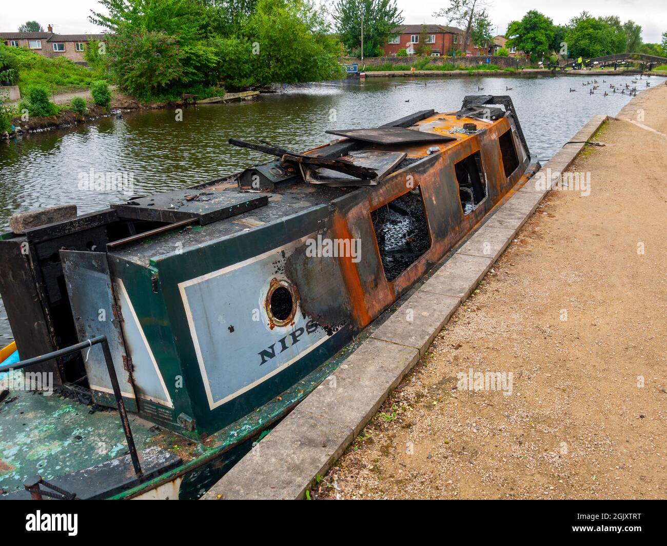 The remains of a burnt out canal narrowboat at Droylsden Marina, on the Ashton Canal, Tameside, Manchester, England, UK Stock Photo