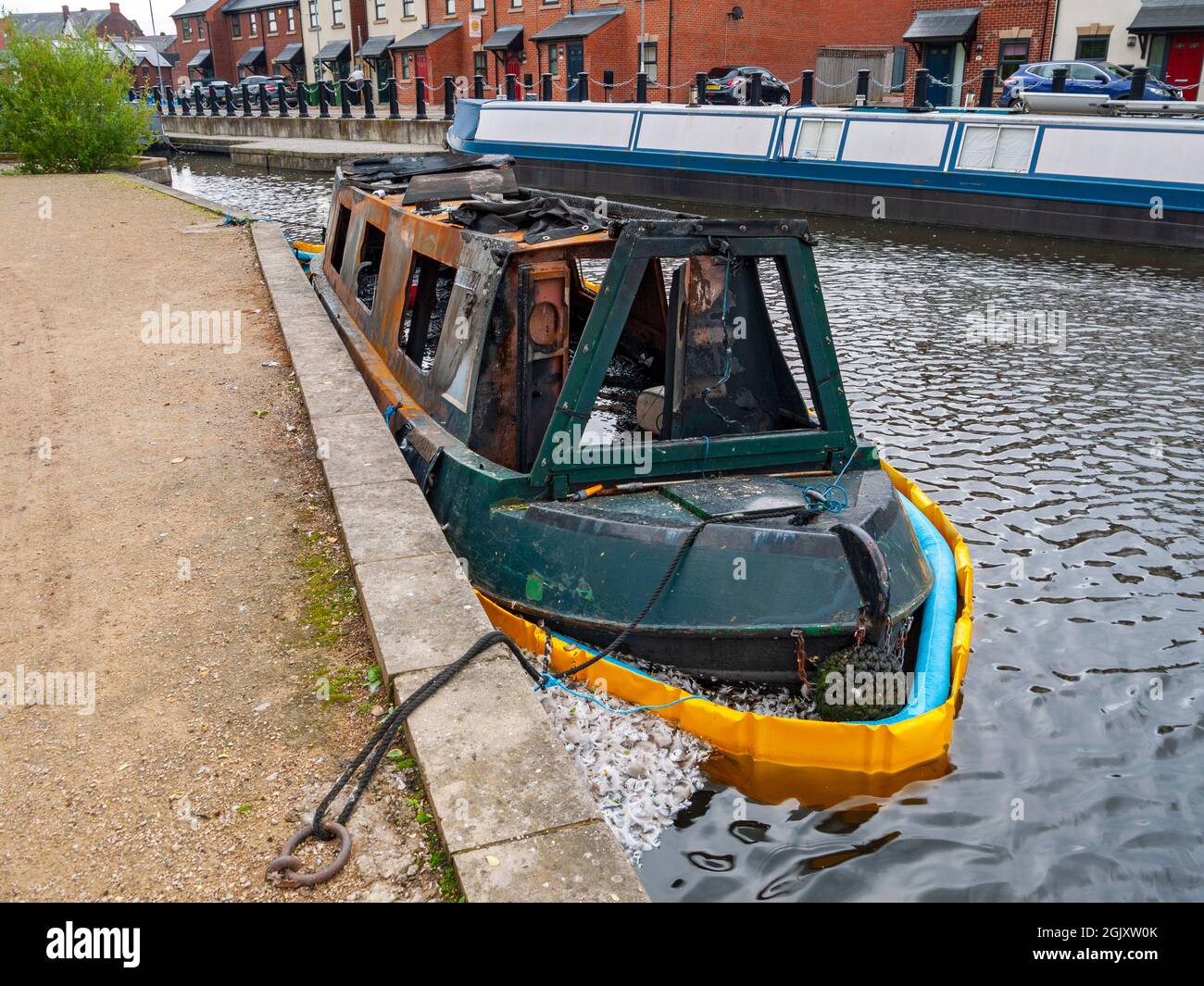 The remains of a burnt out canal narrowboat at Droylsden Marina, on the Ashton Canal, Tameside, Manchester, England, UK Stock Photo