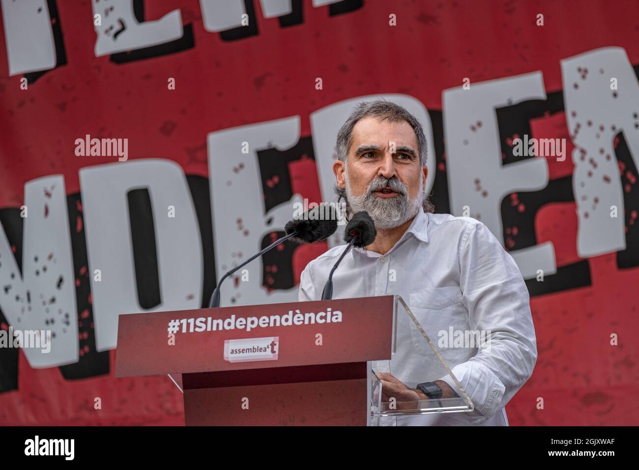 Jordi Cuixart, president of Òmnium Cultural speaks on the stage of Avenida Marquès de l'Argentera.According to figures from the organizers, there are around 400,000 people, according to the Guàrdia Urbana, a little more than 100,000 who convened under the slogan 'Lluitem i Guanyem la indepència' (let's fight and win Independence) have attended the unitary demonstration to celebrate September 11, Diada of Catalonia. Stock Photo