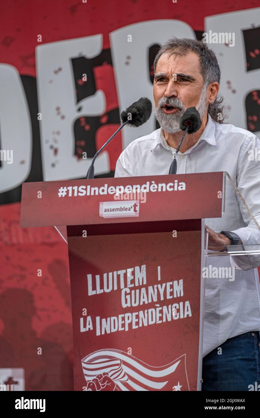 Jordi Cuixart, president of Òmnium Cultural speaks on the stage of Avenida Marquès de l'Argentera.According to figures from the organizers, there are around 400,000 people, according to the Guàrdia Urbana, a little more than 100,000 who convened under the slogan 'Lluitem i Guanyem la indepència' (let's fight and win Independence) have attended the unitary demonstration to celebrate September 11, Diada of Catalonia. Stock Photo