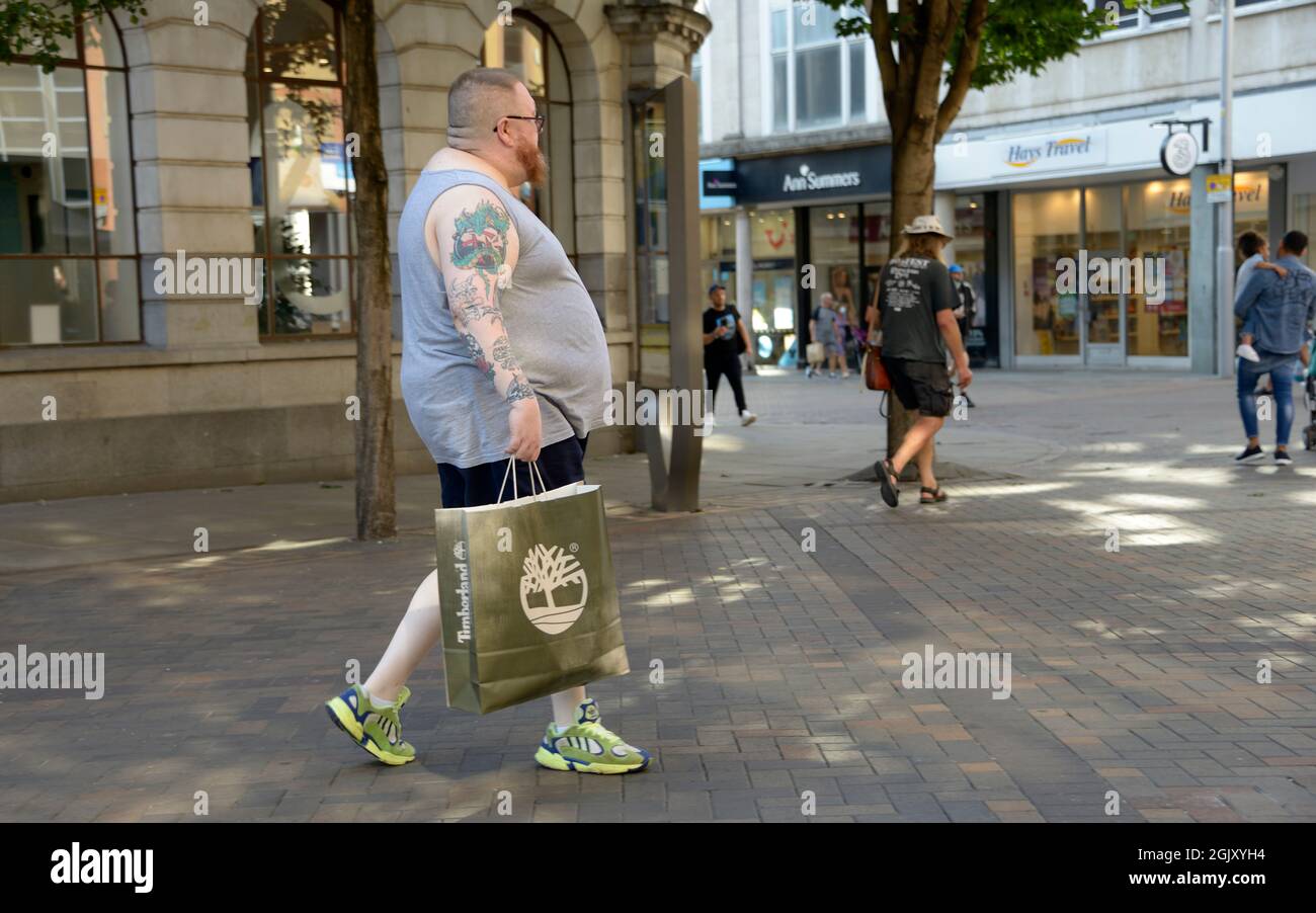 Very large overweight man with tattooed arm Stock Photo