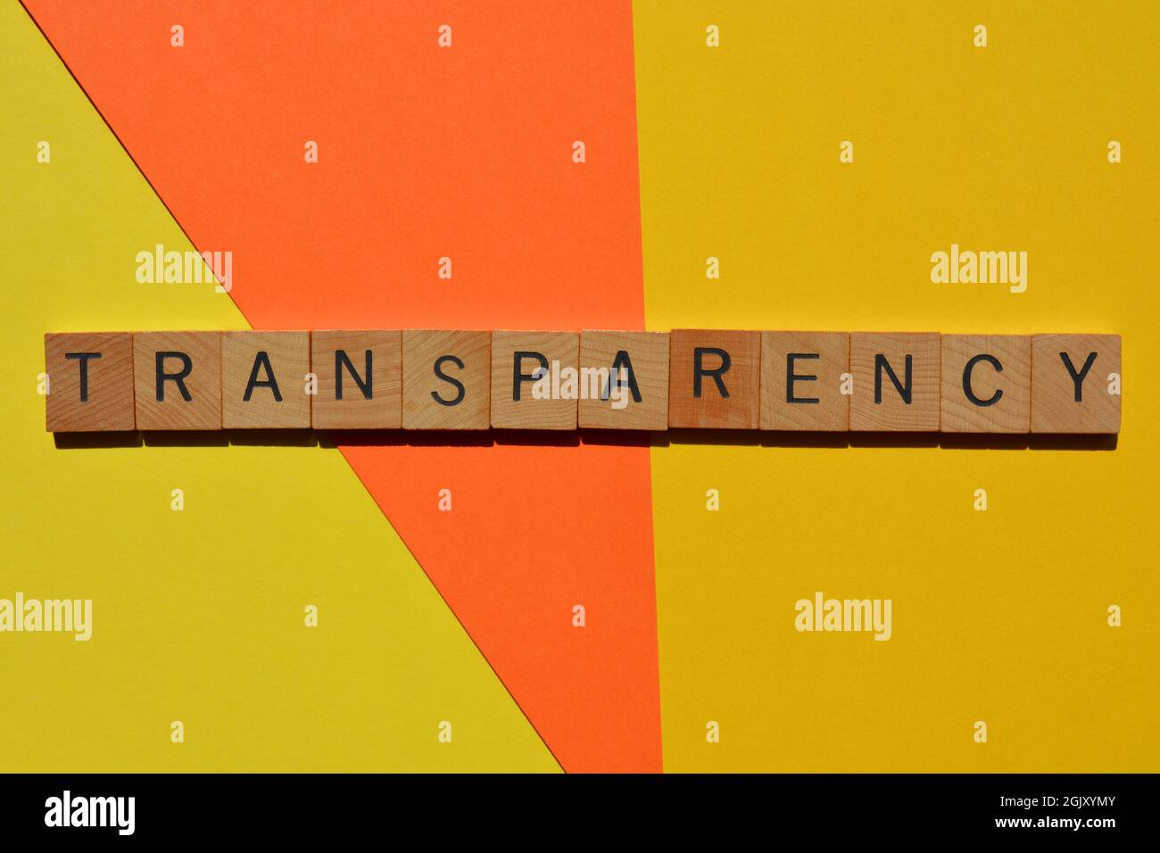 Transparency, word in wooden alphabet letters isolated on brightly coloured background Stock Photo