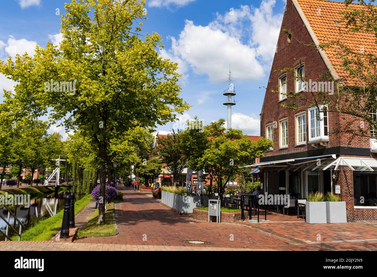 Papenburg, Germany - August 24, 2021: Colorful old village centre of Papenburg along river Ems with canals, little brdiges and ancient ships in Lower Saxony in Germany Stock Photo