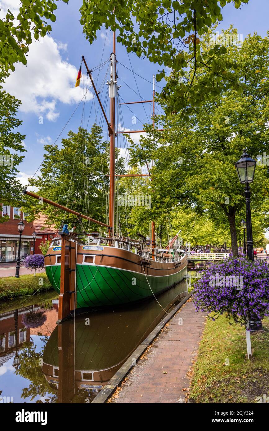 Papenburg, Germany - August 24, 2021: Colorful old village centre of Papenburg along river Ems with canals, little brdiges and ancient ships in Lower Saxony in Germany Stock Photo