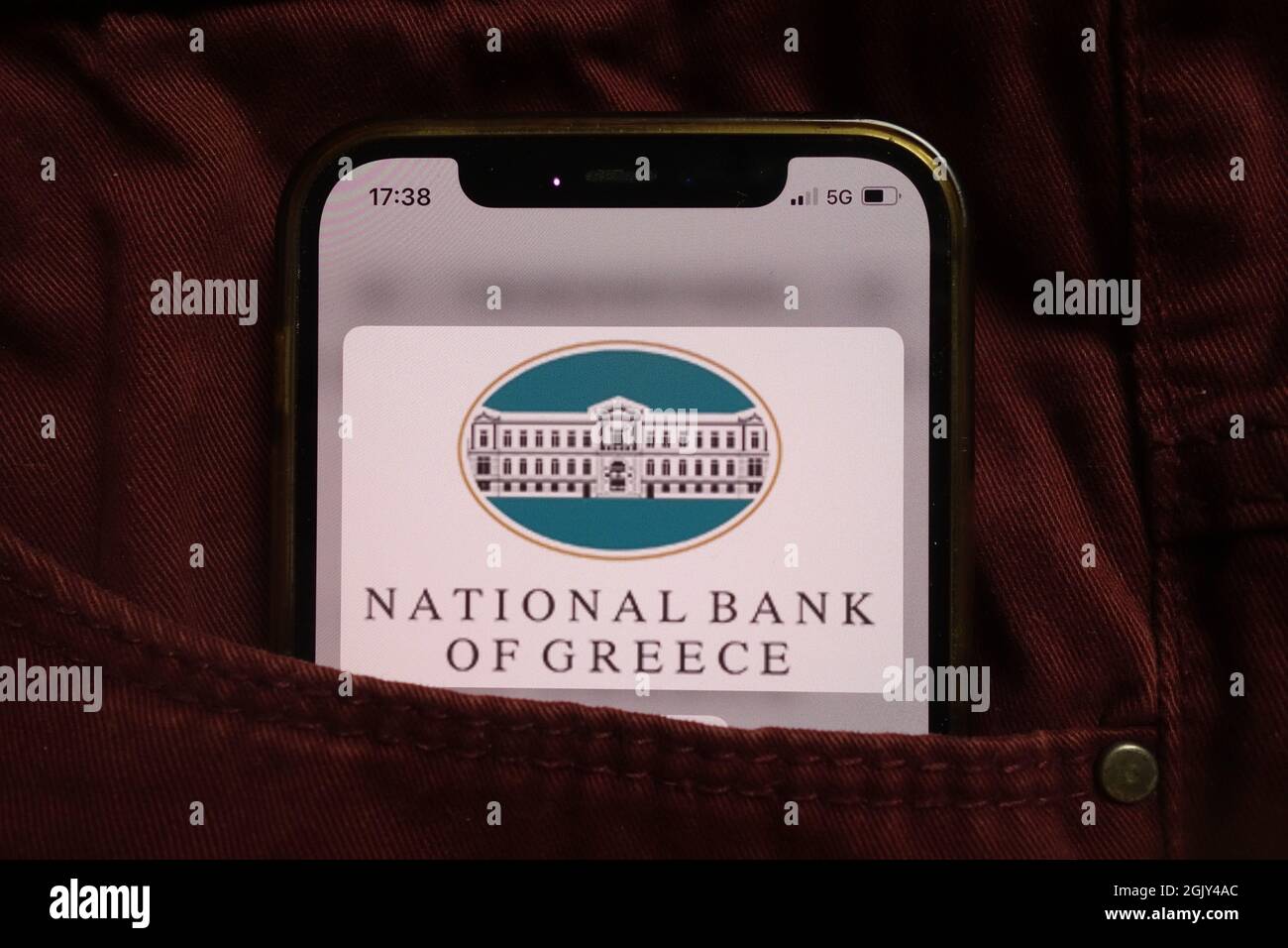 KONSKIE, POLAND - September 04, 2021: National Bank of Greece NBG logo displayed on mobile phone hidden in jeans pocket Stock Photo