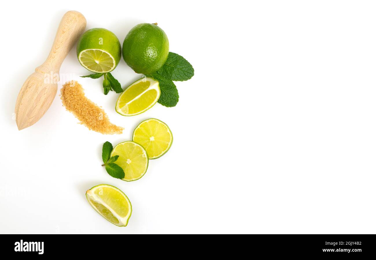 Mojito ingredients. Lime, mint and cane sugar isolated on white background. Sweet sugar, mint leaves and lime. Stock Photo