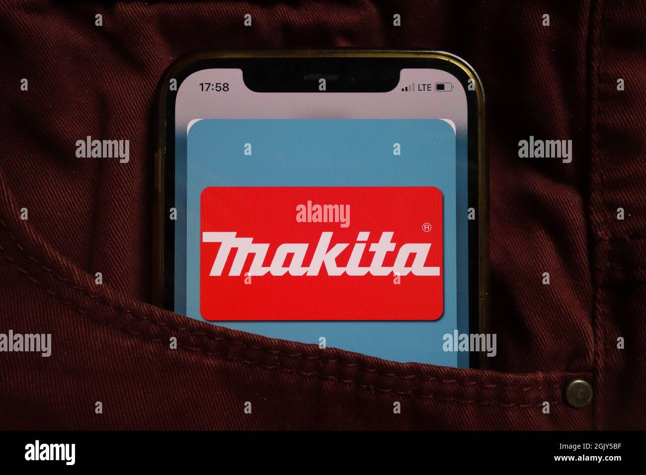 KONSKIE, POLAND - September 04, 2021: Makita Corporation logo displayed on mobile phone hidden in jeans pocket Stock Photo