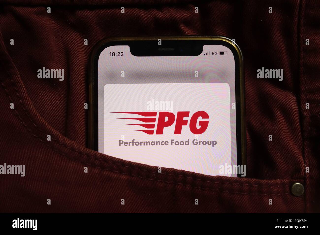 KONSKIE, POLAND - September 04, 2021: Performance Food Group Company PFG logo displayed on mobile phone hidden in jeans pocket Stock Photo