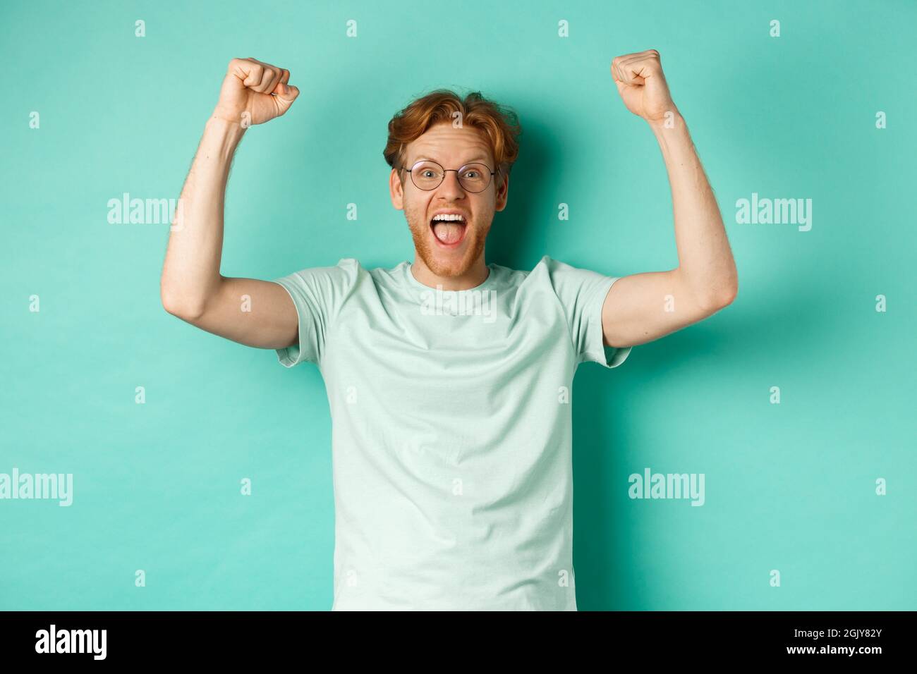 Young redhead man feeling like champion, raising hands up in fist pump  gesture and shouting yes with joy, winning prize, triumphing of success  Stock Photo - Alamy