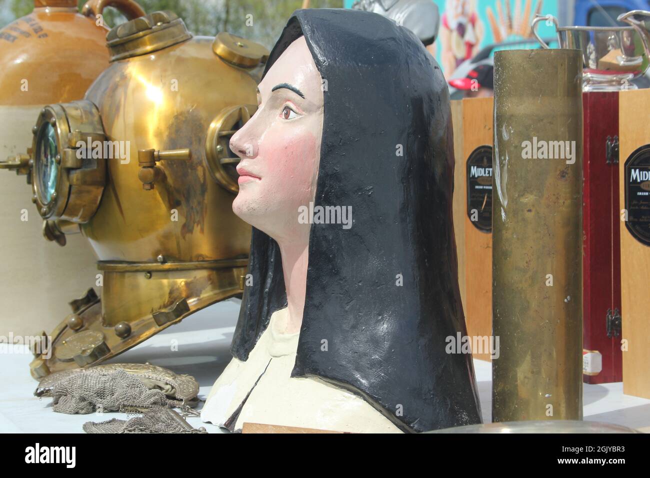 Plaster bust and diving helmet at car boot sale Stock Photo