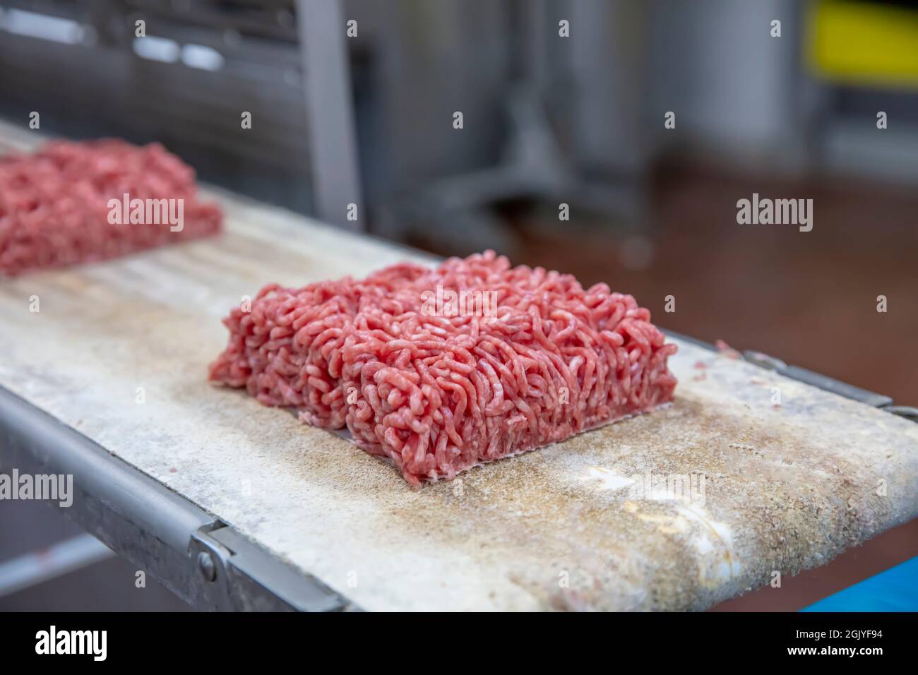 Industrial meat grinder. irreplaceable in the modern kitchen electric universal meat grinder. Minced beef flowing from meat. One pound of minced meat Stock Photo
