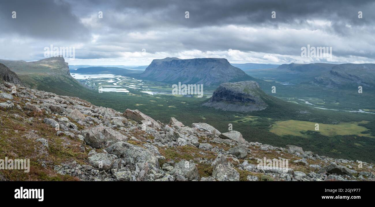 Vast arctic landscape of Sarek National Park in Swedish Lapland with Rapa valley, Tjahkelij, Skierffe, Nammasj peaks and Lajtavrre lake in the back Stock Photo