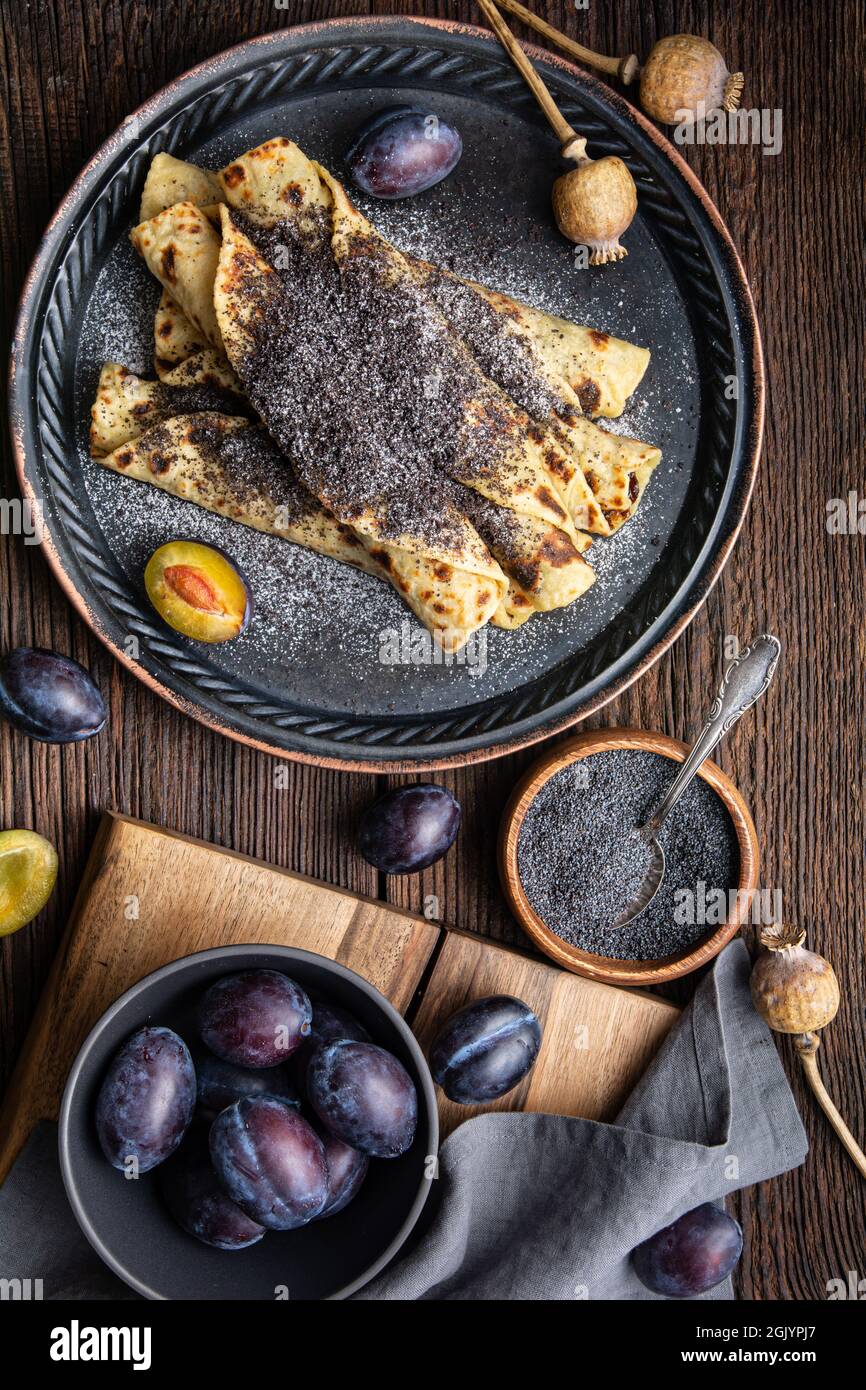 Lokse, traditional Slovak potato flatbread with plum jam and poppy seed filling on wooden background Stock Photo