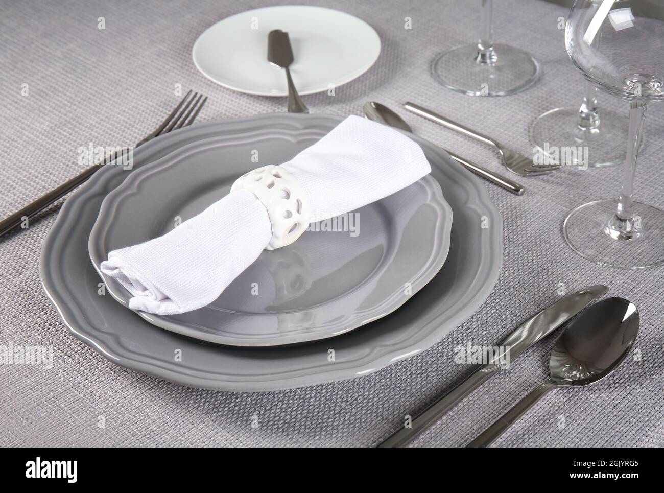 Table setting on light textile background, closeup Stock Photo - Alamy