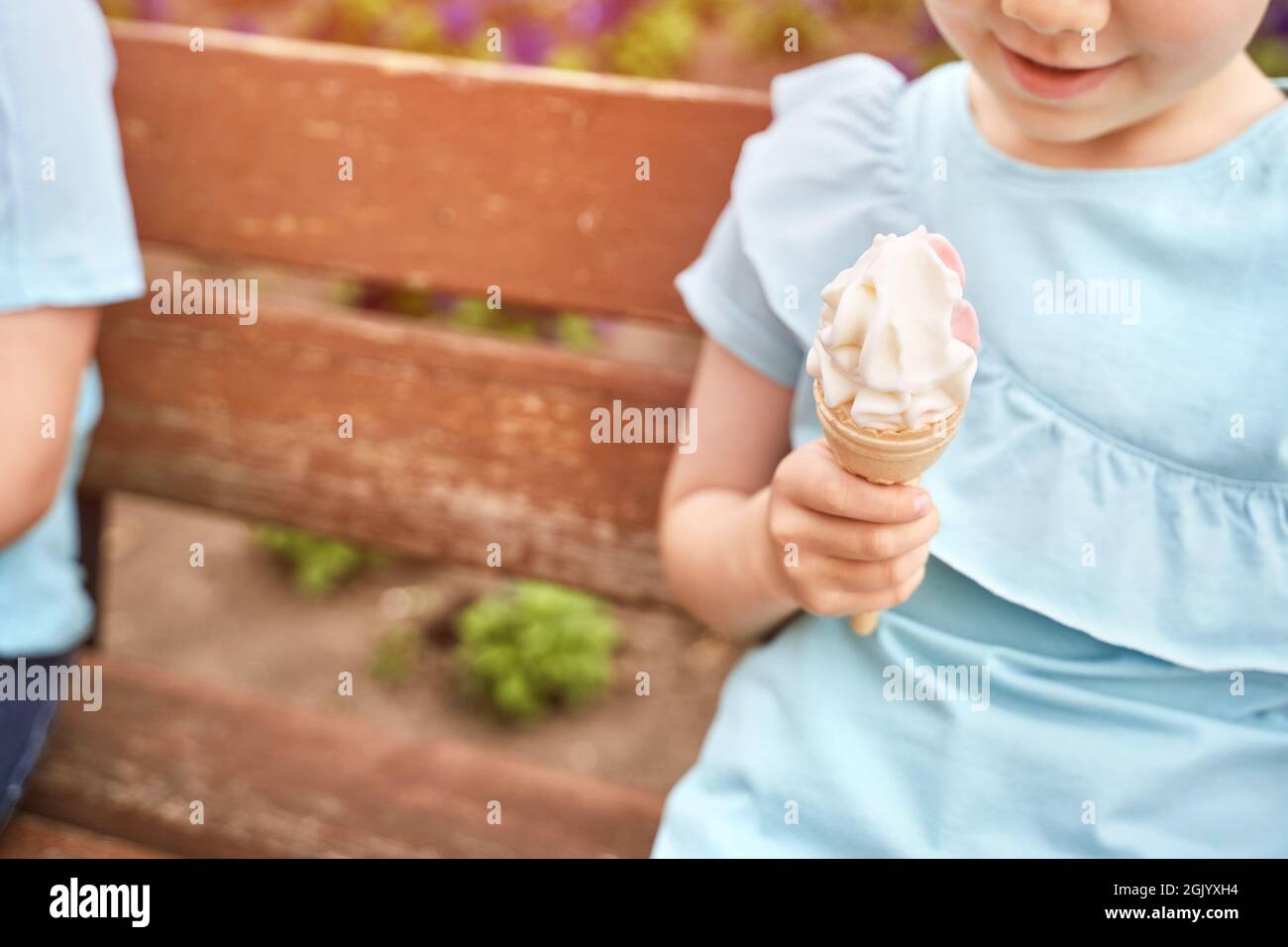 Pretty fun kid eating ice cream at park. Vacation concept. Staycation lifestyle Stock Photo