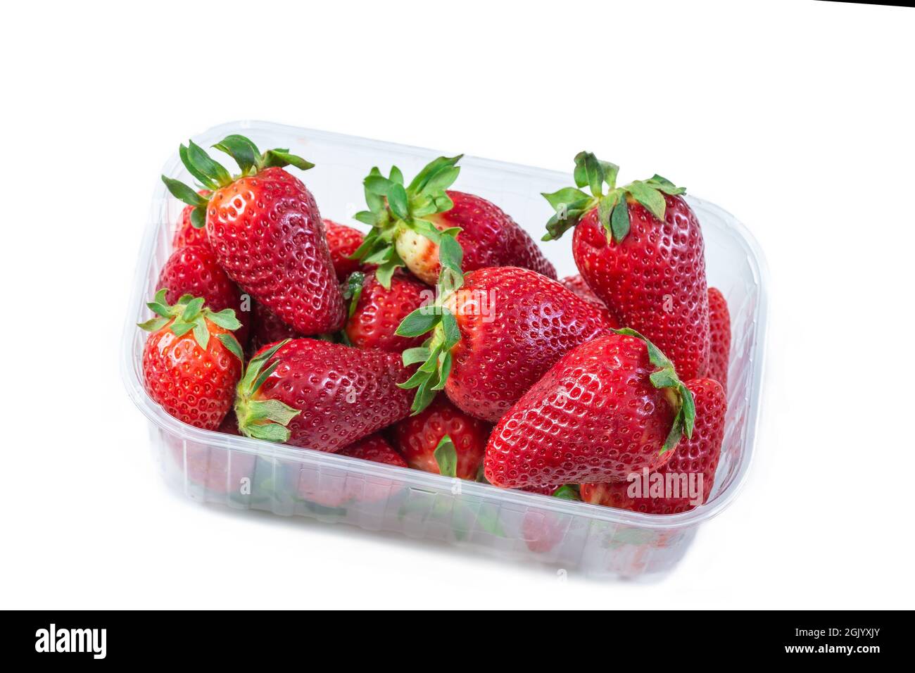 Strawberry in plastic, transparent container box, isolated on white background. Stock Photo