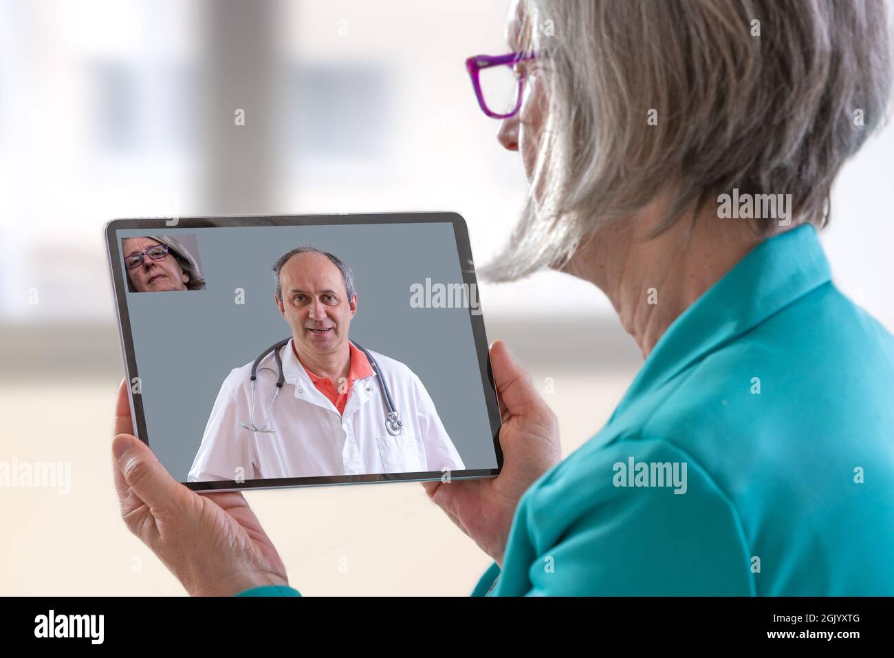 Patient with tablet, having remote consultation with doctor. Stock Photo