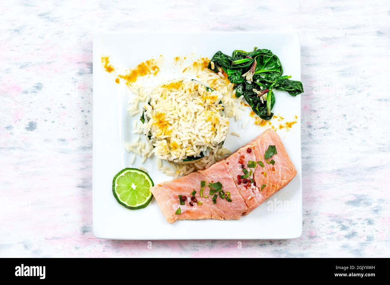 Grilled salmon with spinach, lemon and thyme. Stock Photo