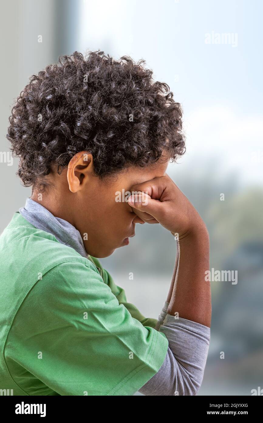 Upset problem child with head in hands , concept depression stress or frustration Stock Photo