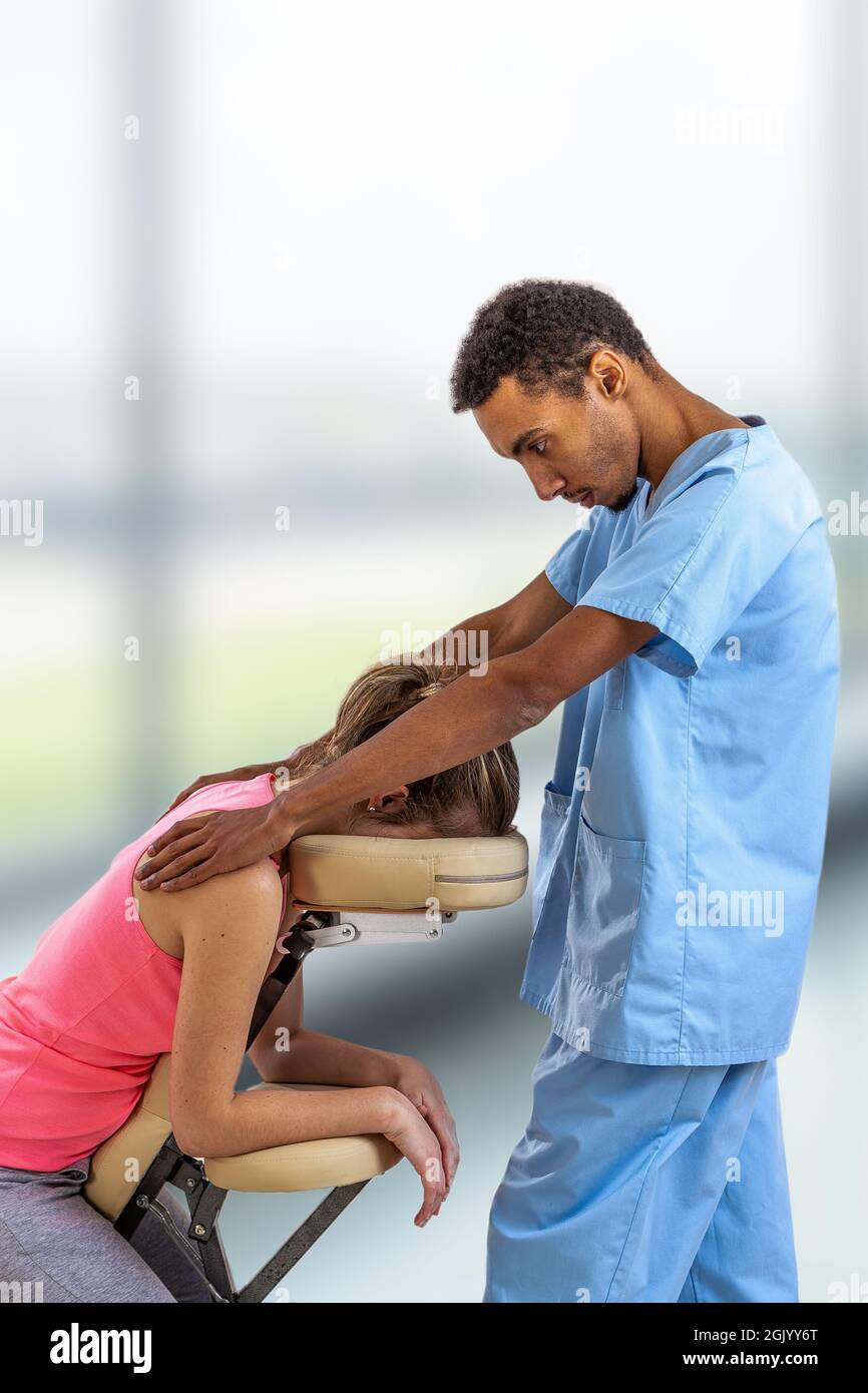 https://c8.alamy.com/comp/2GJYY6T/physiotherapist-giving-back-massage-to-a-patient-sitting-in-a-massage-chair-in-the-clinic-2GJYY6T.jpg