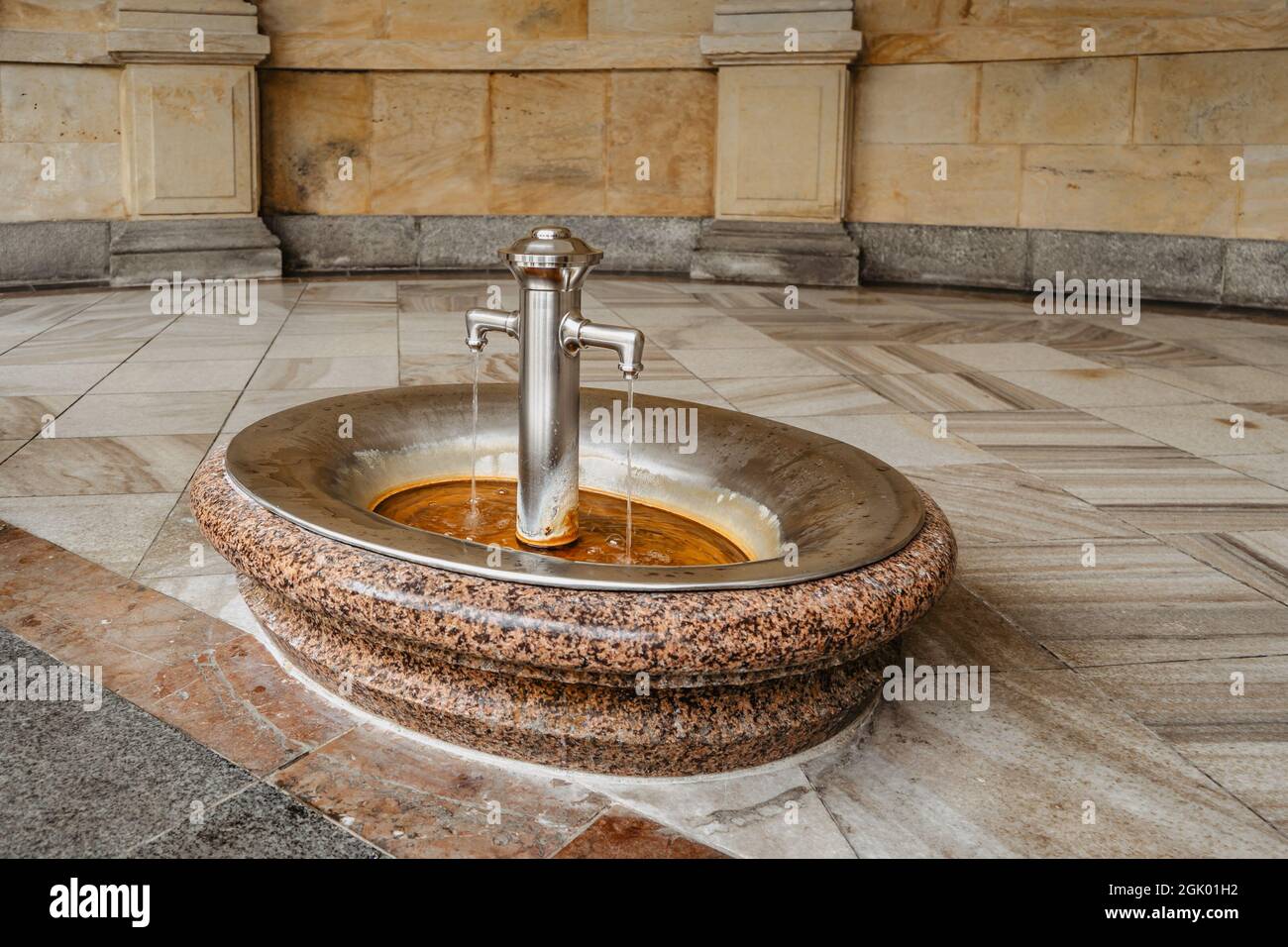 Healing water from hot mineral spring in famous spa town Karlovy Vary