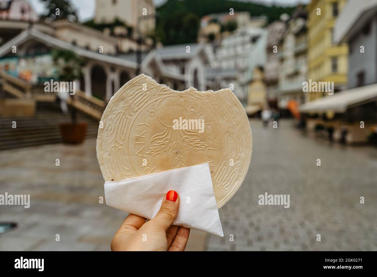 Famous Carlsbad wafer,CZ: lazenske oplatky, originated in 1867. Woman hand holding traditional Czech sweet cookie snack made in Karlovy Vary, famous s Stock Photo