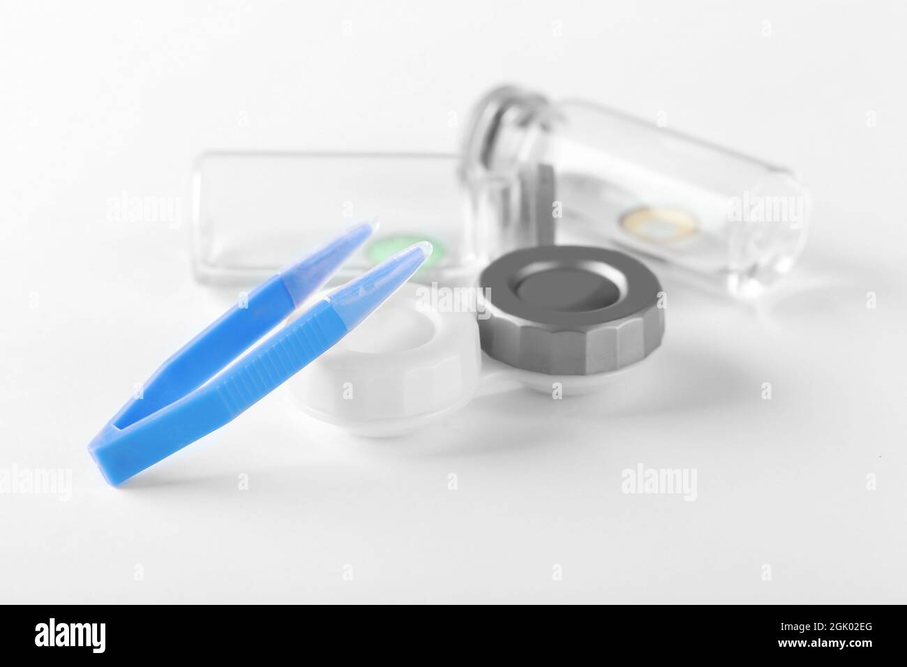 Tweezers and container for contact lenses on white background Stock Photo Alamy