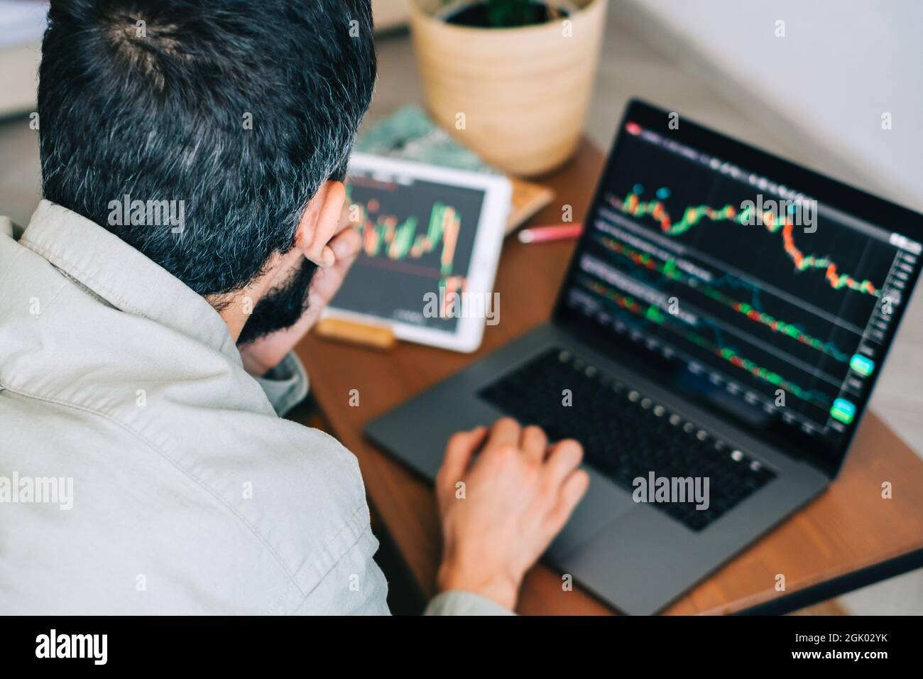 Caucasian businessman trading online, using computer technology ...