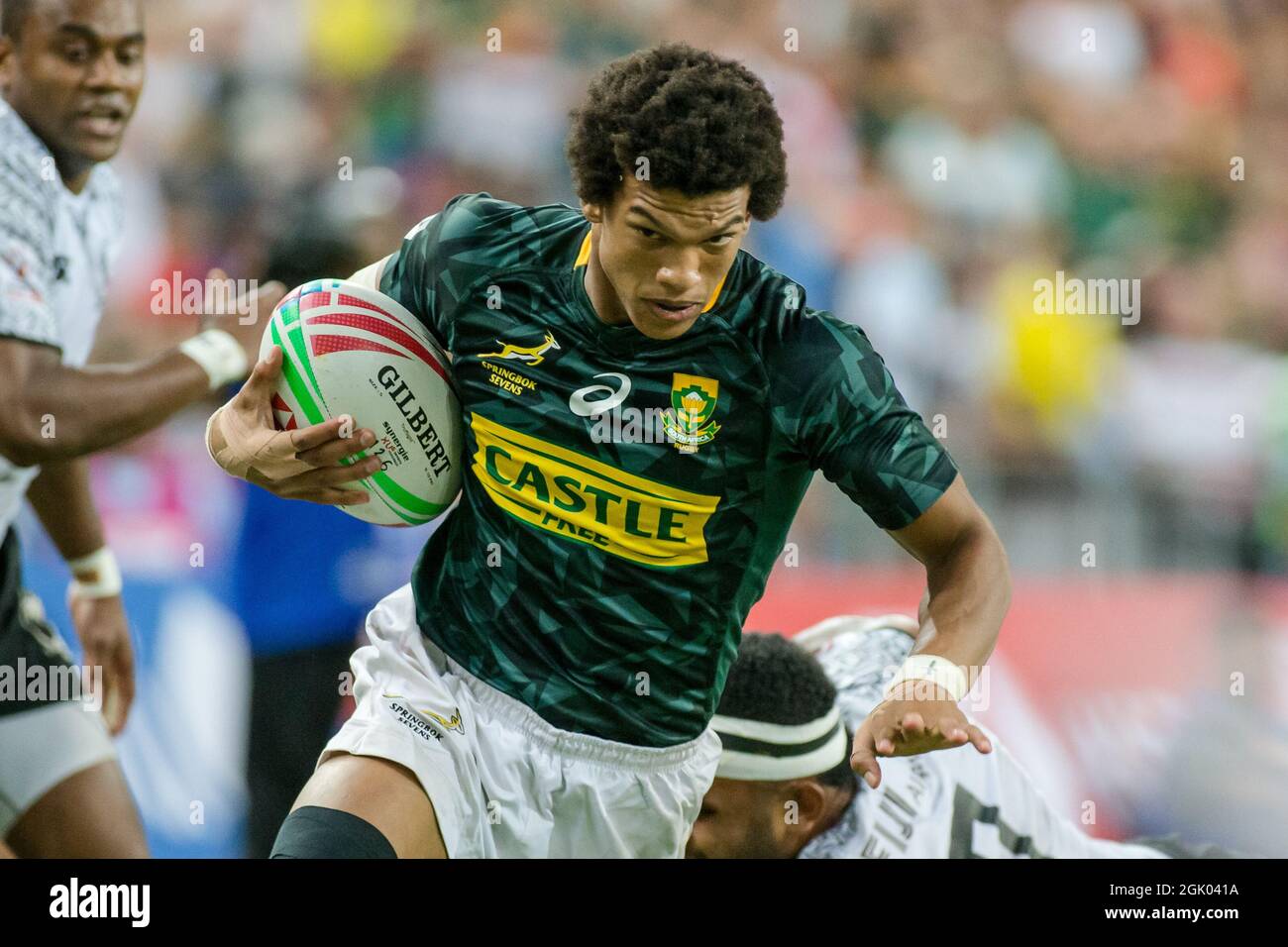 SINGAPORE-APRIL 14: Kurt-Lee Arendse of South Africa 7s Team (green) in action against Fiji 7s team (white) during the Cup Final match of HSBC World Rugby Singapore Sevens on April 14, 2019 at National Stadium in Singapore Stock Photo