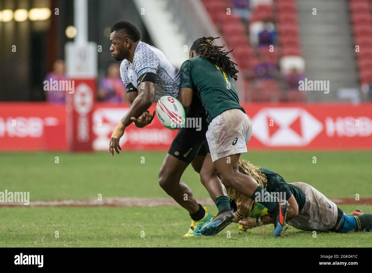 SINGAPORE-APRIL 14: South Africa 7s Team (green) plays against Fiji 7s team (white) during the Cup Final match of HSBC World Rugby Singapore Sevens on April 14, 2019 at National Stadium in Singapore Stock Photo