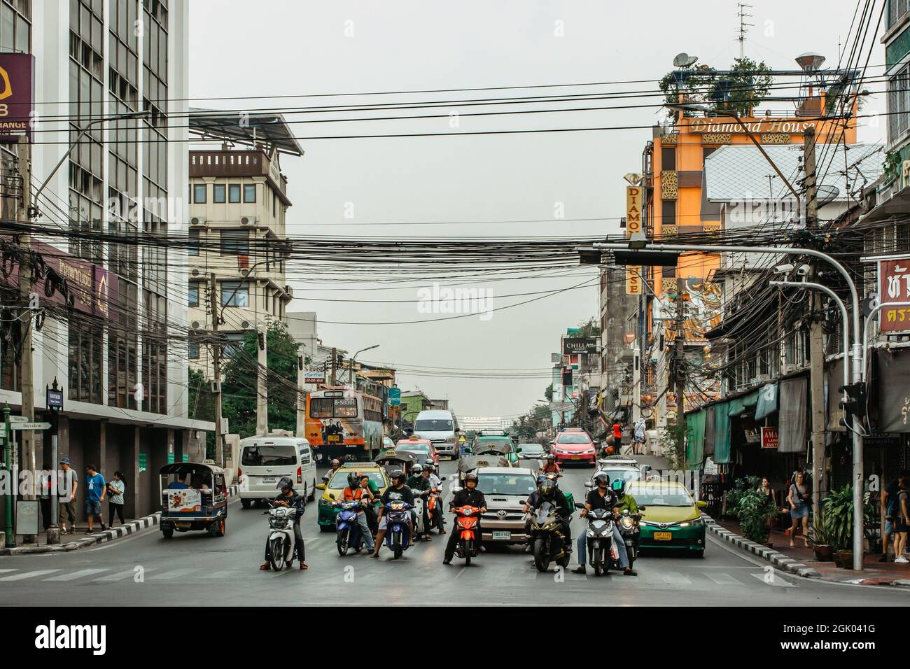 Bangkok, Thailand - January 17,2020.Busy street in Chinatown,junction with cars,buses,motorbikes,people.Morning traffic.Thai crowded transportation Stock Photo