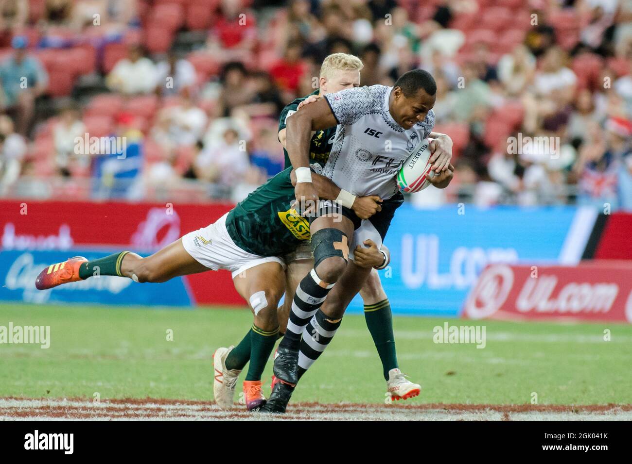 SINGAPORE-APRIL 14: Fiji 7s Team (white plays against South African 7s team (green) during the Cup Final match of HSBC World Rugby Singapore Sevens on April 14, 2019 at National Stadium in Singapore Stock Photo