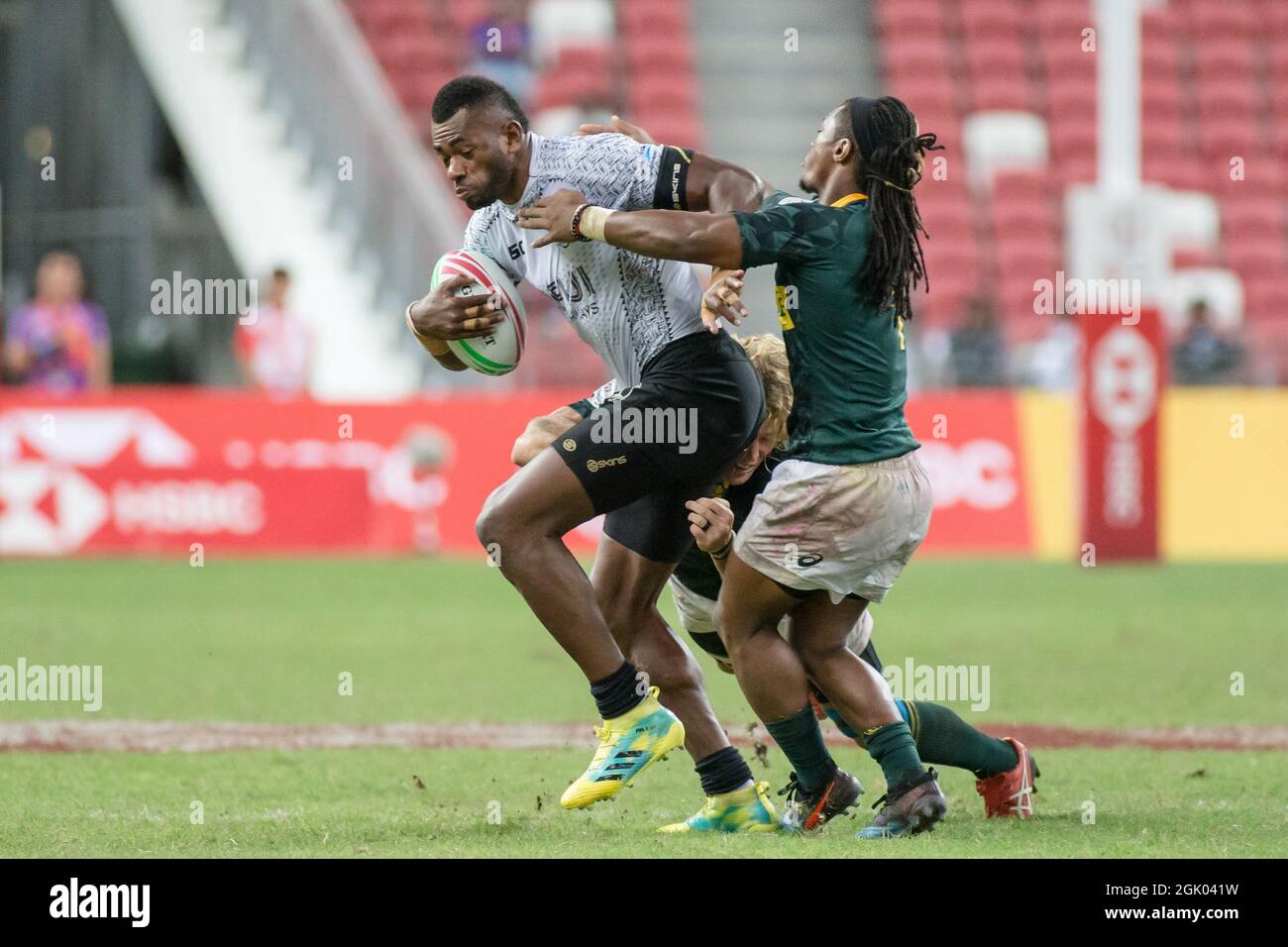 SINGAPORE-APRIL 14: South Africa 7s Team (green) plays against Fiji 7s team (white) during the Cup Final match of HSBC World Rugby Singapore Sevens on April 14, 2019 at National Stadium in Singapore Stock Photo