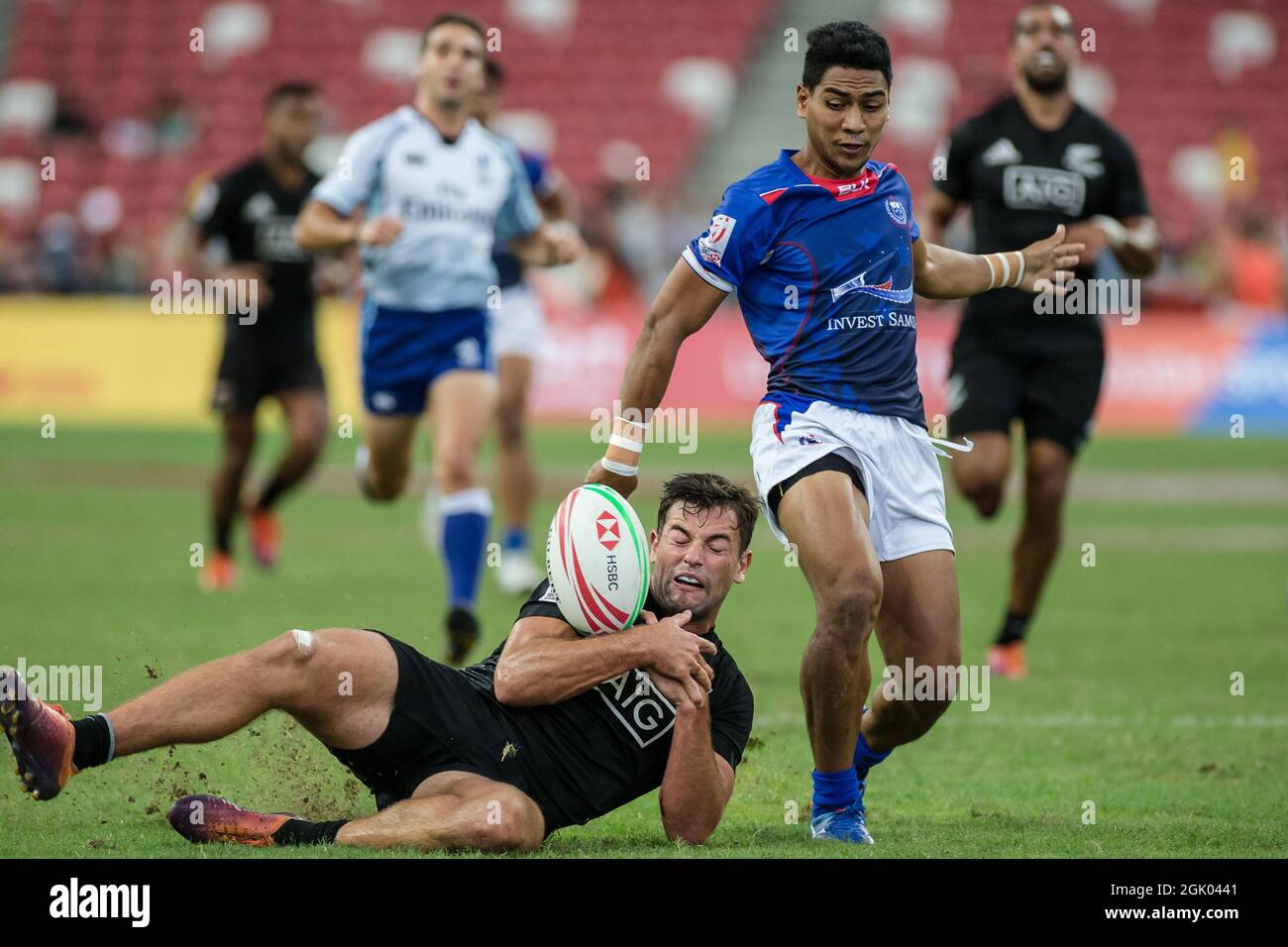 SINGAPORE-APRIL 14: Andrew Knewstubb of New Zealand 7s Team (left/black) plays against a Samoa 7s team player (blue) during Day 2 of HSBC World Rugby Singapore Sevens on April 14, 2019 at National Stadium in Singapore Stock Photo