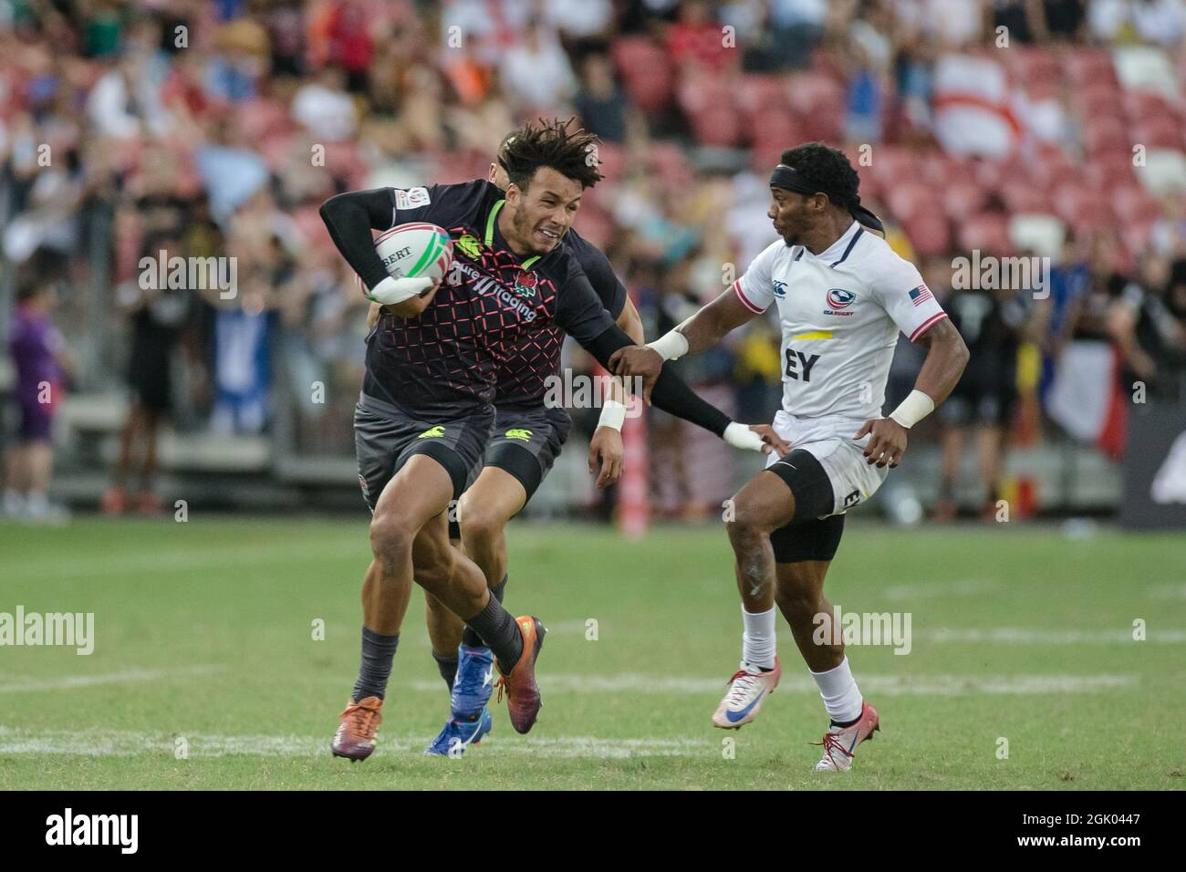 SINGAPORE-APRIL 14: Ryan Olowofela of England 7s Team (blue) in action against Carlin Isles of USA 7s team (white) during the Bronze medal match of HSBC World Rugby Singapore Sevens on April 14, 2019 at National Stadium in Singapore Stock Photo