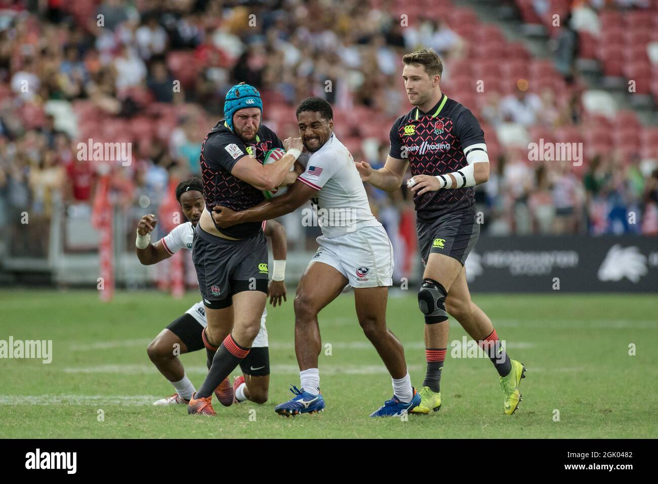 SINGAPORE-APRIL 14:England 7s Team (blue) plays against USA 7s team (white) during the Bronze medal match of HSBC World Rugby Singapore Sevens on April 14, 2019 at National Stadium in Singapore Stock Photo