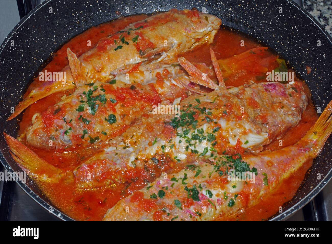 Typical Italian food 'Triglie alla livornese' with red mullet Stock Photo
